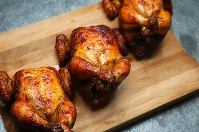 Photo of Delicious grilled whole chickens on grey table