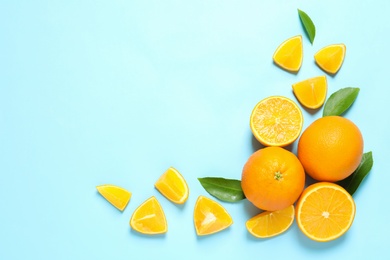 Flat lay composition with ripe oranges and space for text on color background