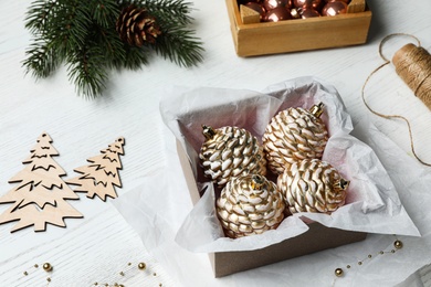 Composition with beautiful Christmas baubles on white wooden table