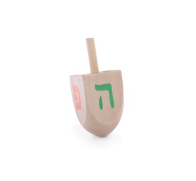 Photo of Wooden Hanukkah traditional dreidel with letters Pe and He isolated on white