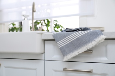 Photo of Clean kitchen towel on counter at home, closeup