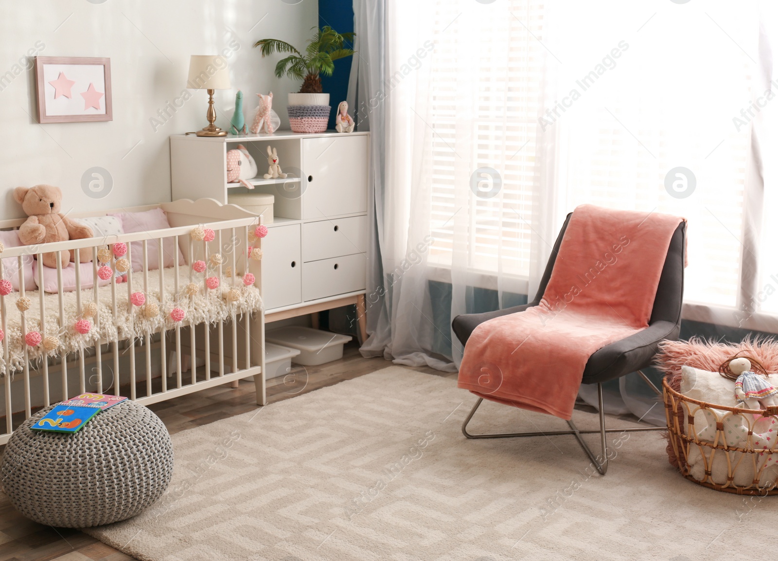 Photo of Cozy baby room interior with comfortable crib