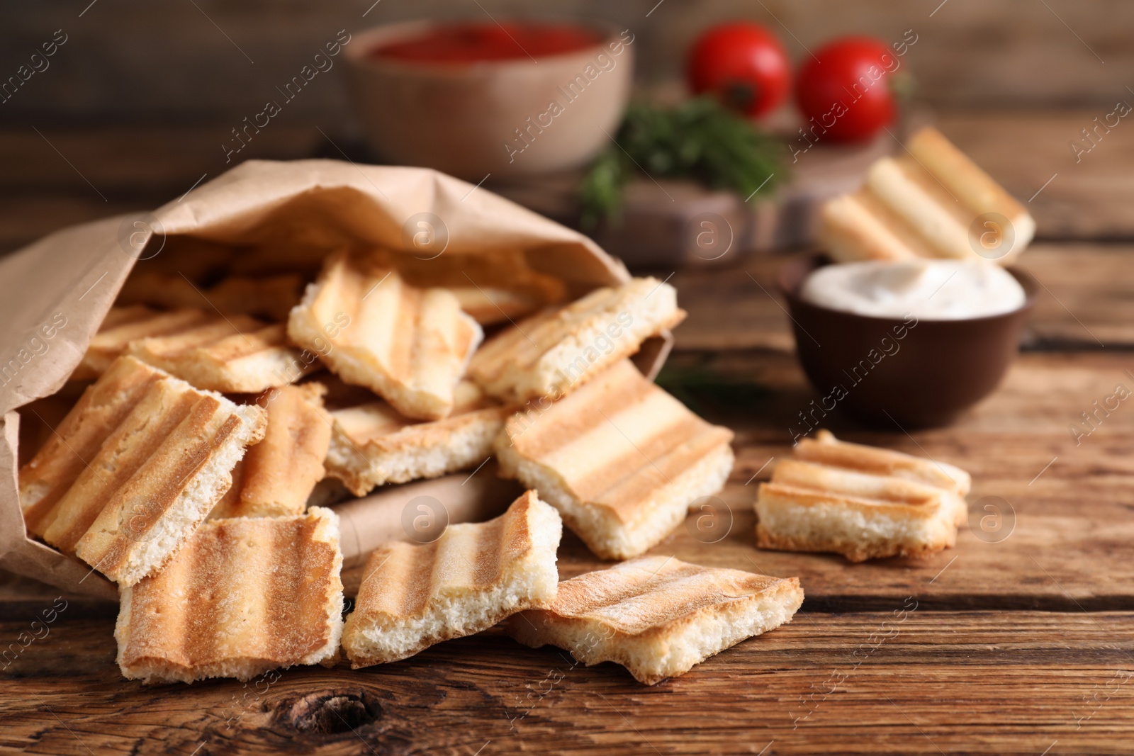 Photo of Delicious pita chips on wooden table, closeup