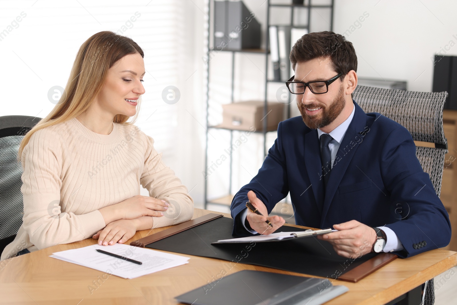 Photo of Woman having meeting with lawyer in office