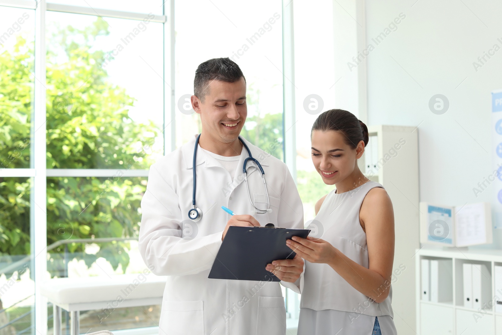 Photo of Young doctor speaking to patient in hospital