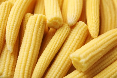 Photo of Tasty fresh yellow baby corns as background, closeup