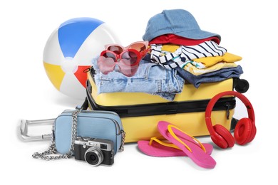 Photo of Suitcase, clothes and beach accessories isolated on white. Summer vacation