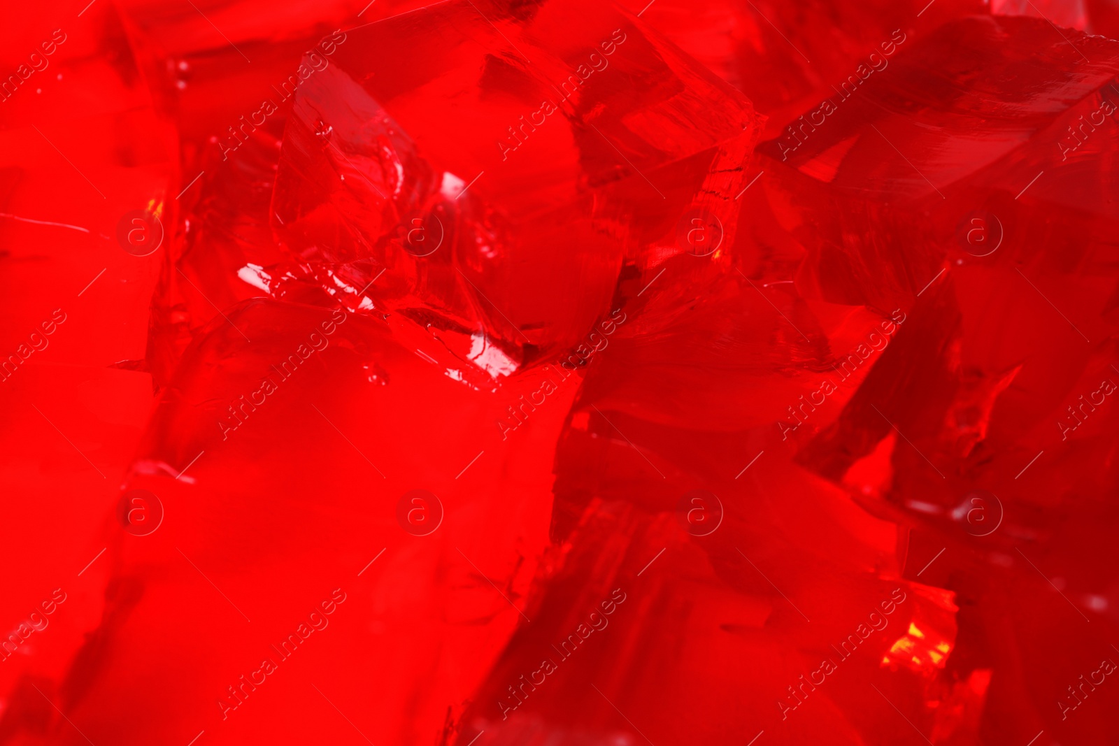 Photo of Delicious red jelly cubes as background, closeup