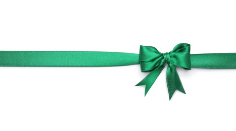 Photo of Green ribbon with bow on white background