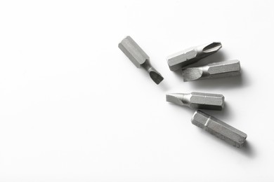 Different screwdriver bits on white background, top view