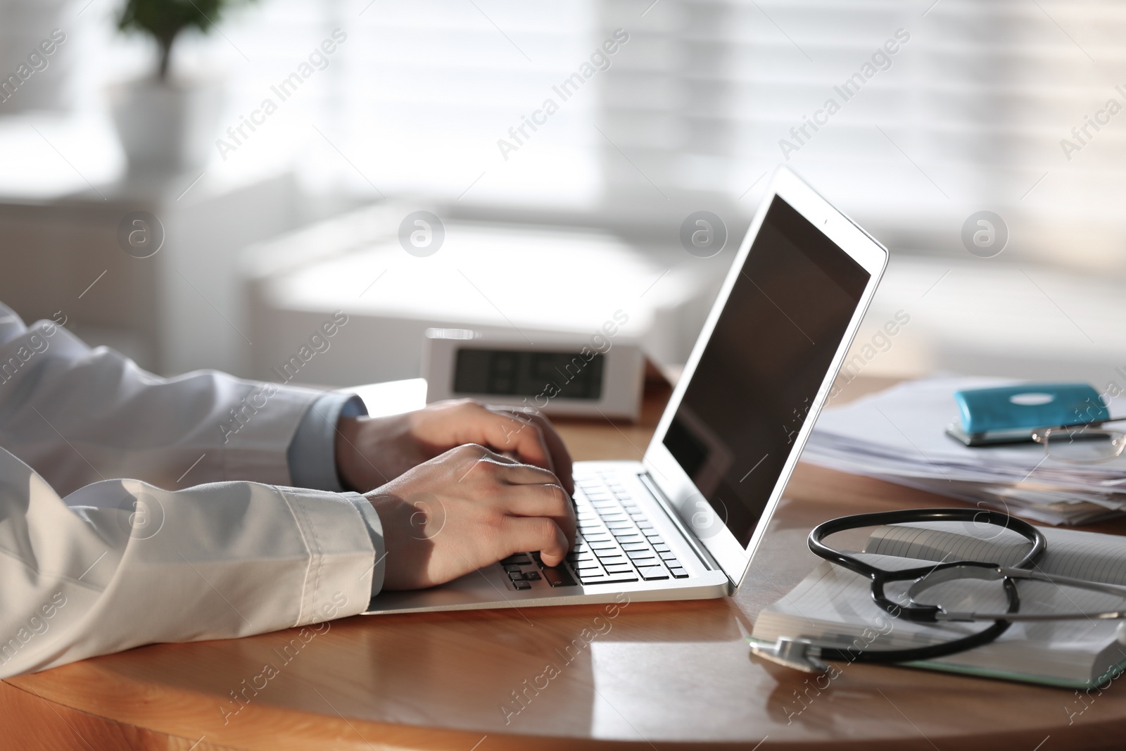 Photo of Professional doctor working on laptop in office, closeup