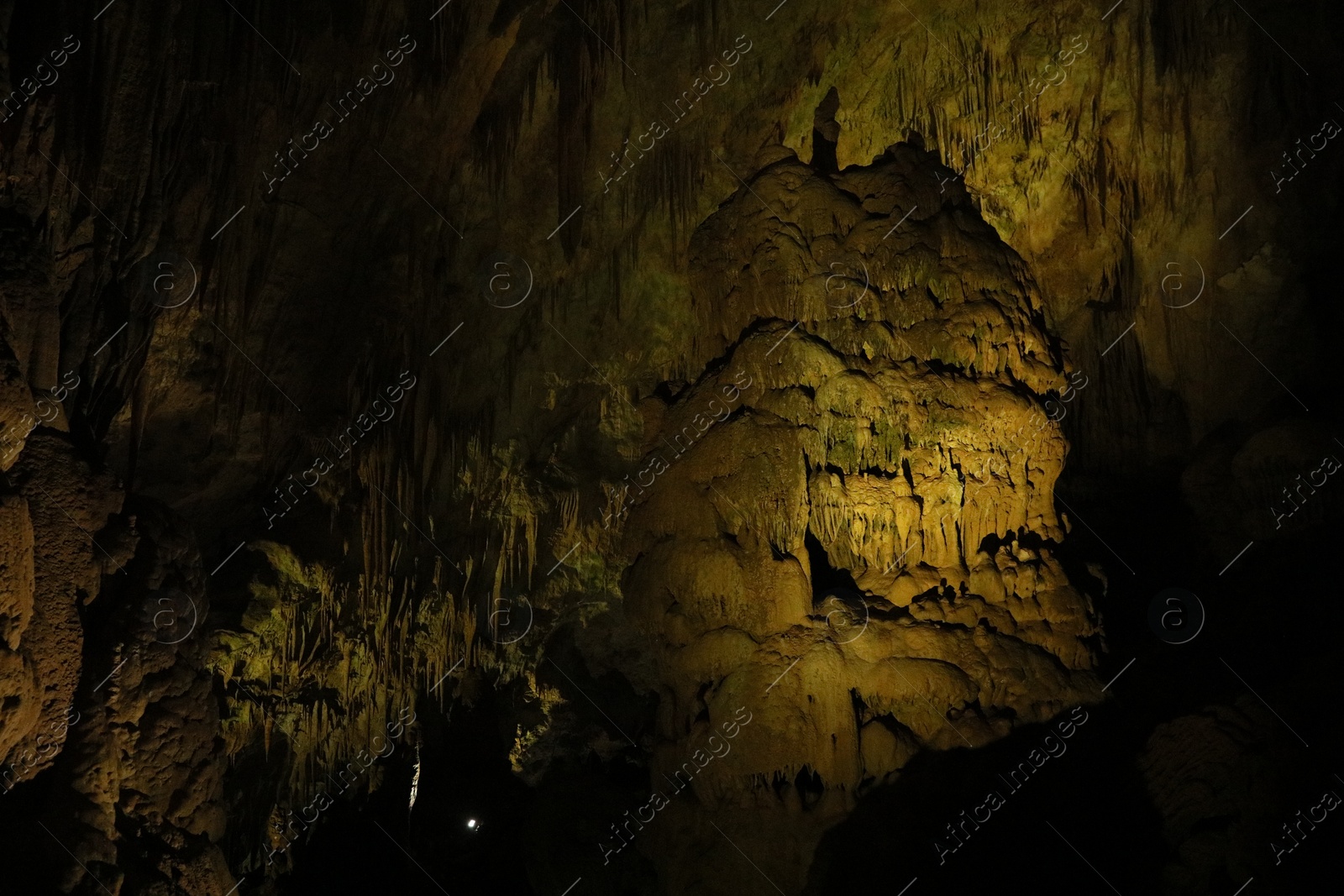 Photo of Picturesque view of many stalactite and stalagmite formations in cave