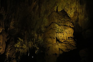 Photo of Picturesque view of many stalactite and stalagmite formations in cave