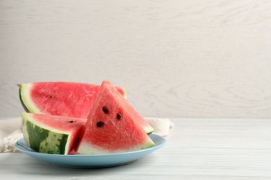 Photo of Delicious fresh watermelon slices on white wooden table. Space for text