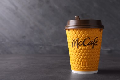 Photo of MYKOLAIV, UKRAINE - AUGUST 12, 2021: Hot McDonald's drink on grey table. Space for text