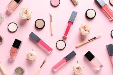 Photo of Beautiful composition with lipsticks and flowers on color background, flat lay