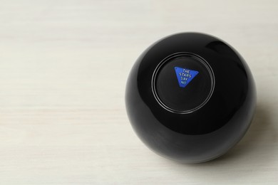 Photo of Magic eight ball with prediction The Stars Say No on white table, space for text