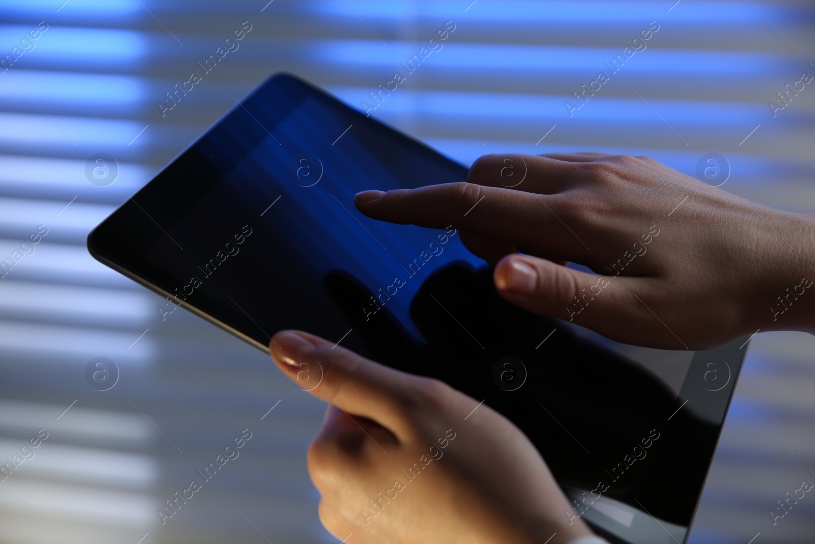 Photo of Businesswoman using modern tablet in office, closeup