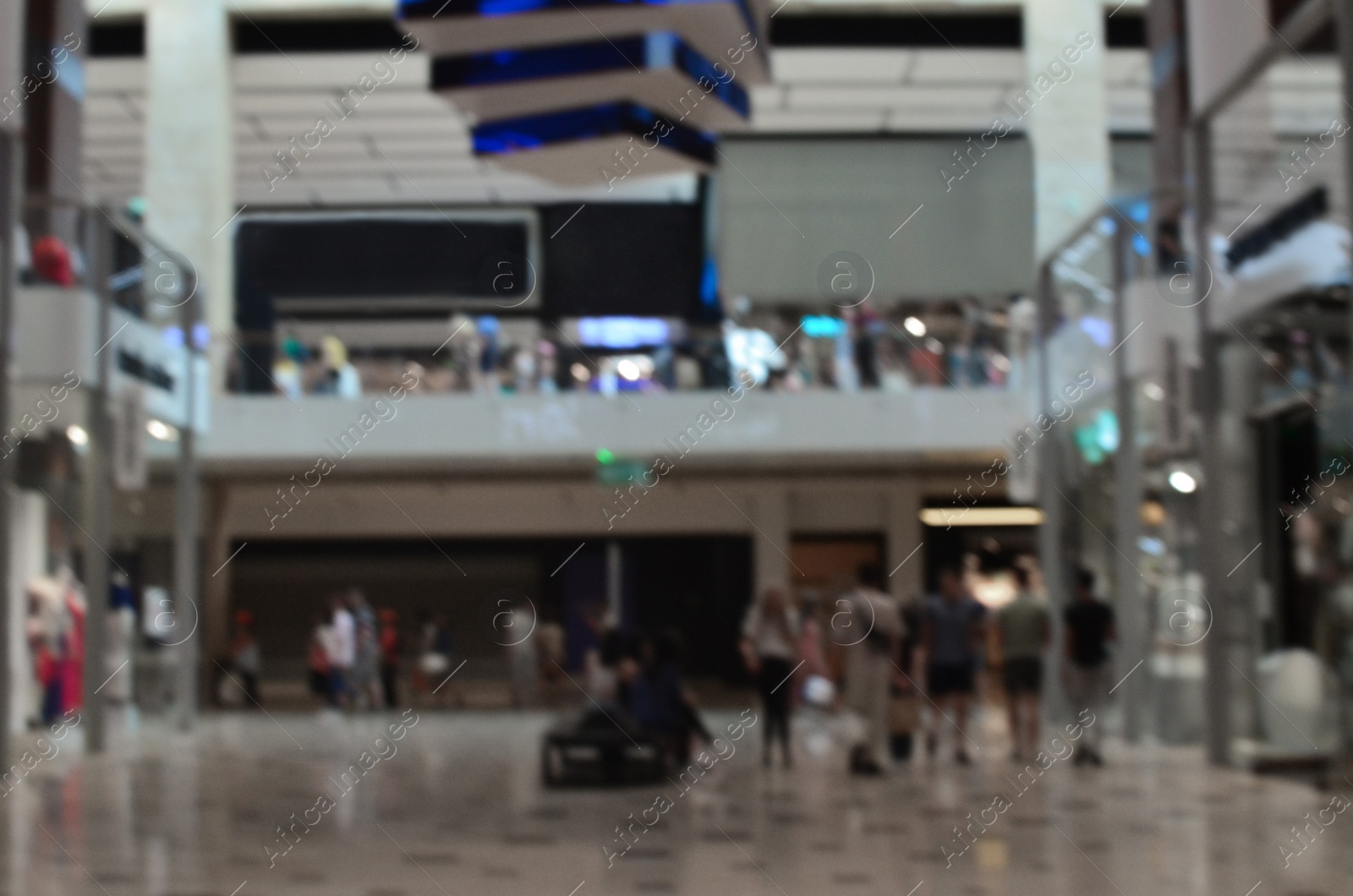 Photo of Blurred view of big shopping mall with many stores