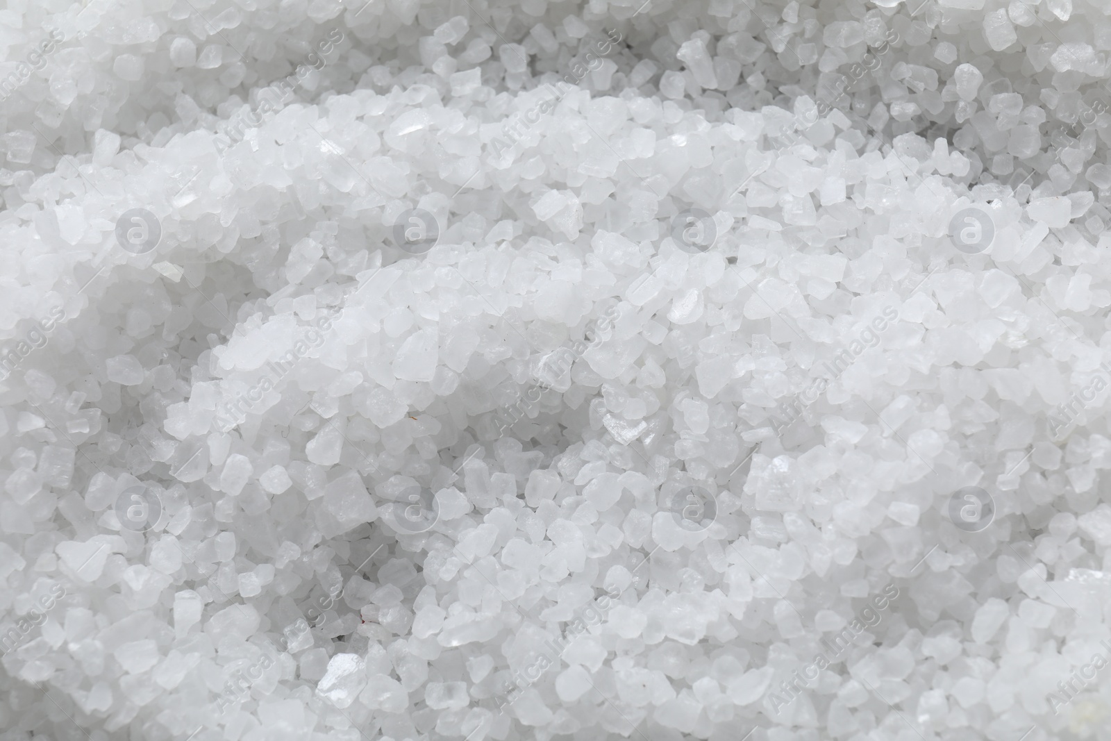 Photo of White natural salt as background, top view