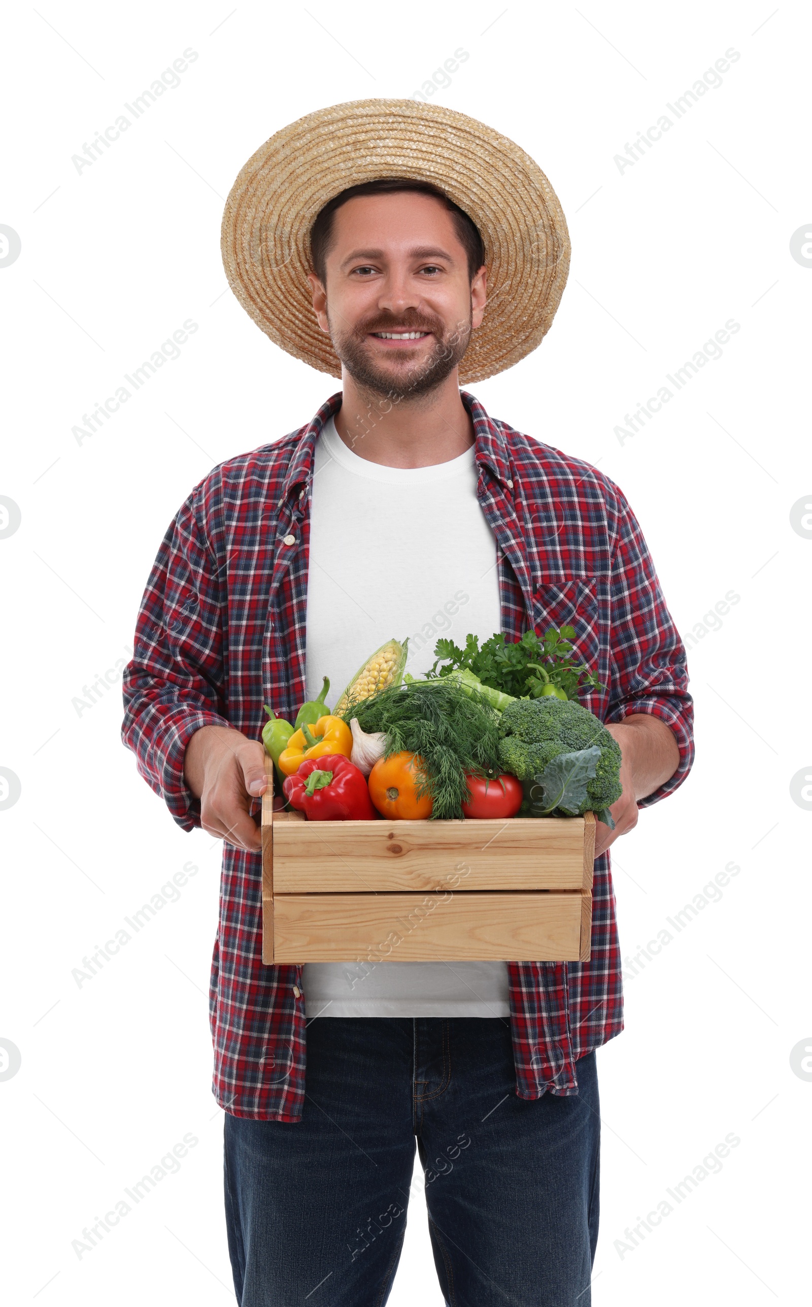 Photo of Harvesting season. Happy farmer holding wooden crate with vegetables on white background