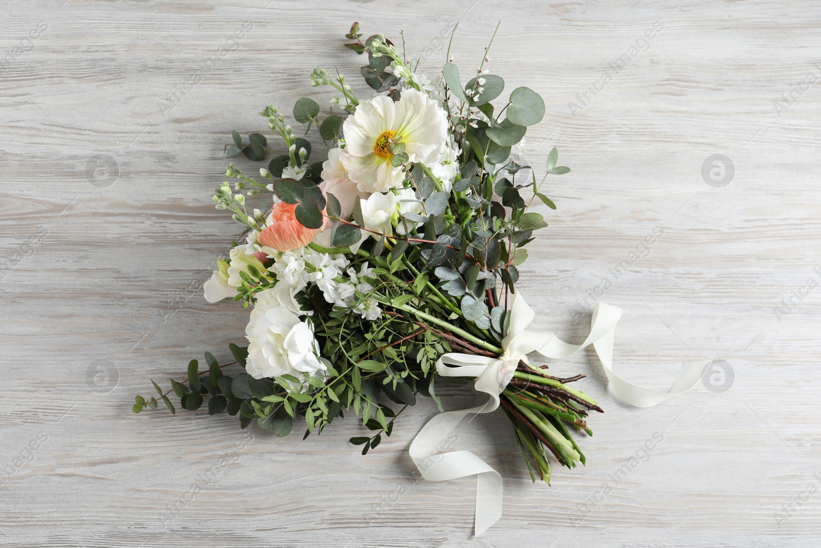 Photo of Bouquet of beautiful flowers on wooden table, top view