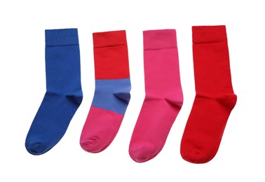 Photo of Different colorful socks on white background, top view