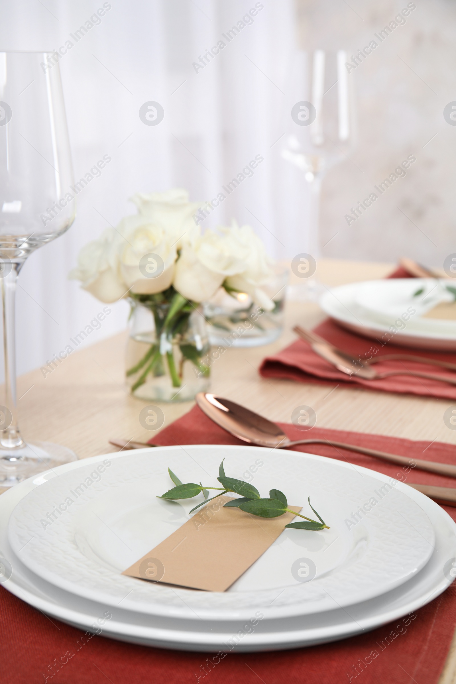 Photo of Elegant festive table setting with blank card in restaurant