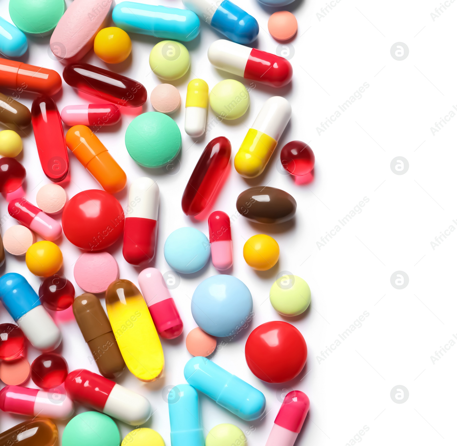 Photo of Lots of different colorful pills isolated on white, top view