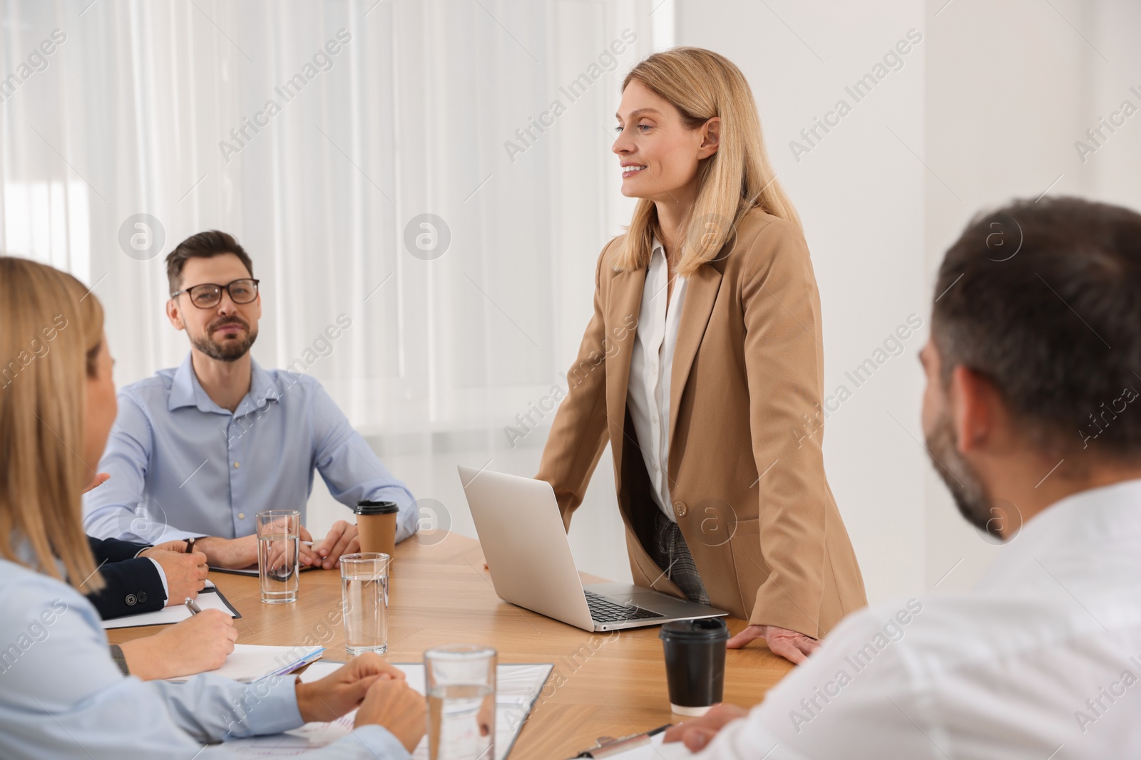 Photo of Businesswoman having meeting with her employees in office