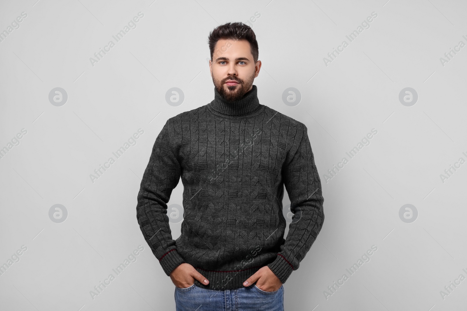 Photo of Handsome man in stylish sweater on white background