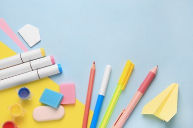 Photo of Flat lay composition with different school stationery on light blue background. Back to school