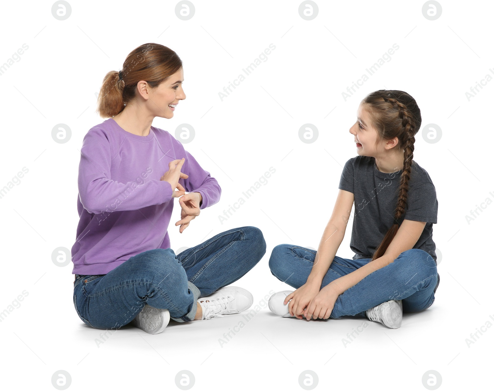 Photo of Hearing impaired mother and her child talking with help of sign language on white background