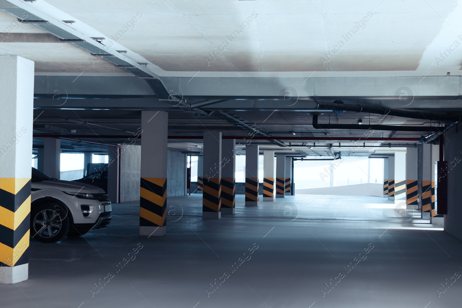 Photo of Open parking garage with car on sunny day