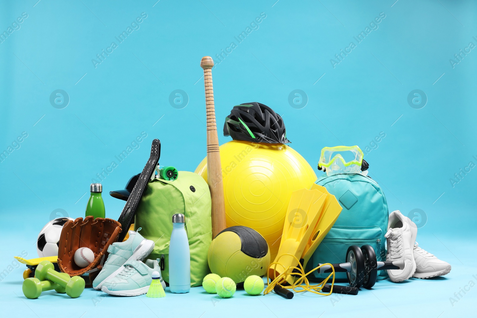 Photo of Many different sports equipment on light blue background