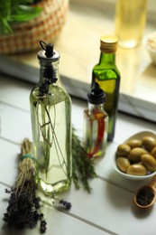 Different cooking oils and ingredients on white wooden table indoors