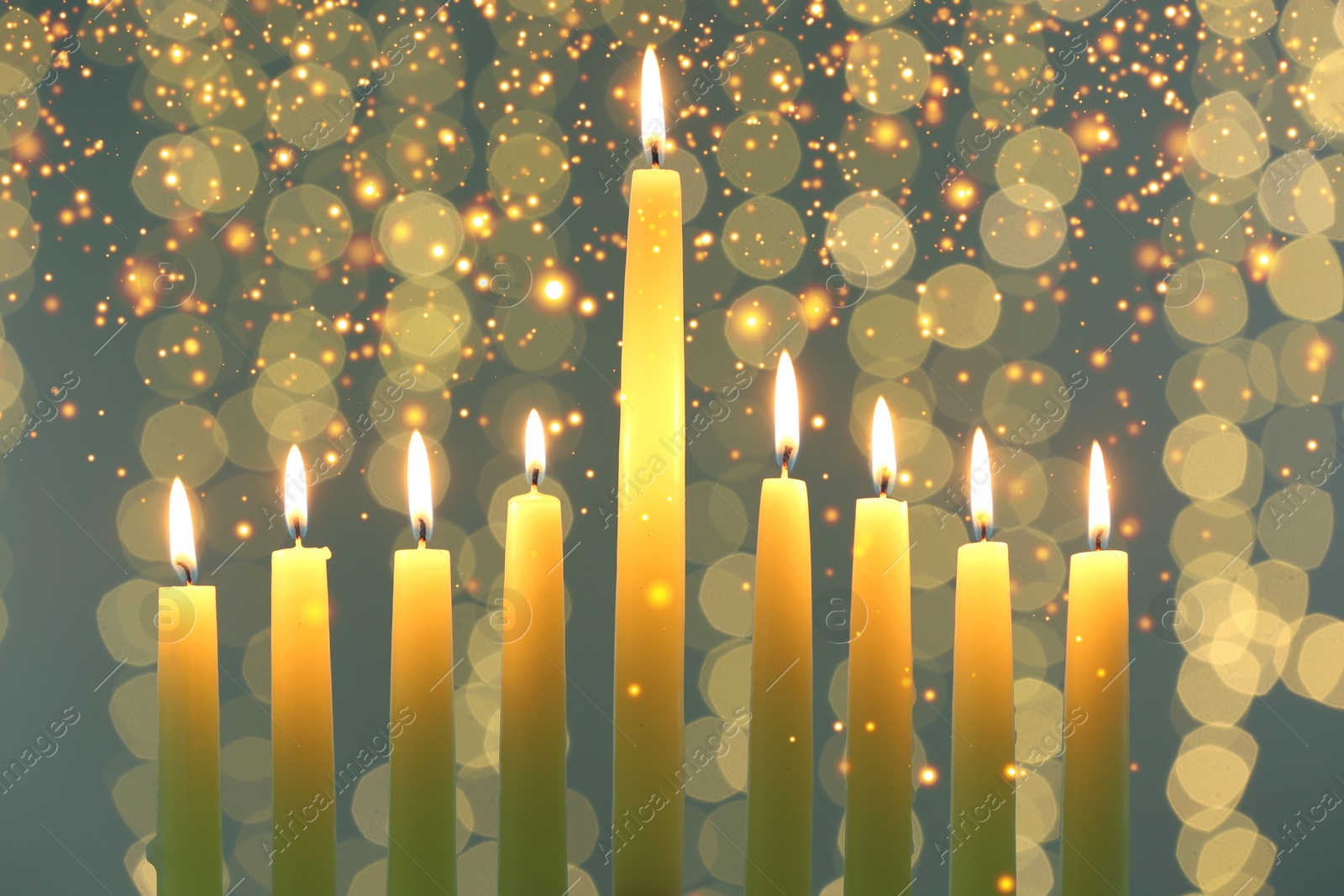Image of Hanukkah celebration. Burning candles against blurred lights, closeup