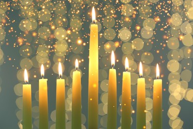 Hanukkah celebration. Burning candles against blurred lights, closeup