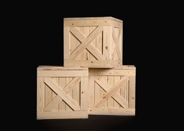 Photo of Group of wooden crates on black background