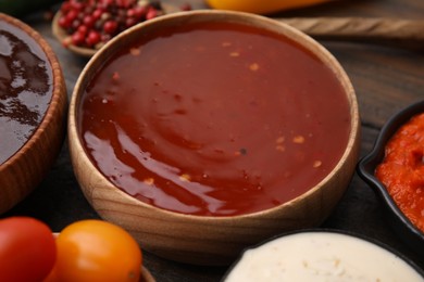 Photo of Homemade marinade in bowl on wooden table, closeup