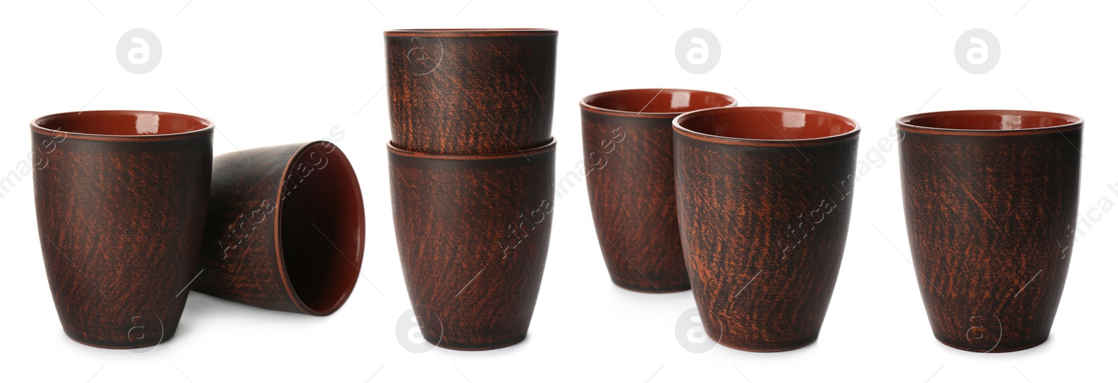 Image of Set with stylish brown clay cups on white background. Banner design