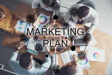 Image of Digital marketing plan. People working at table, top view