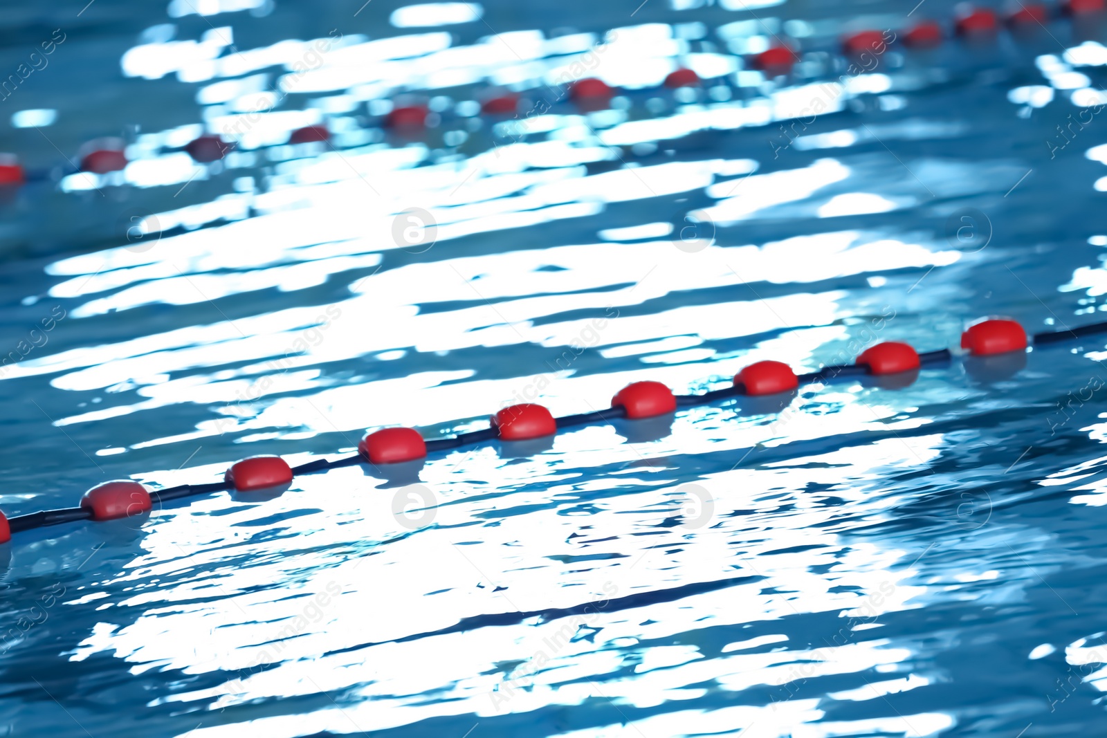 Photo of Modern swimming pool with blue water, indoors