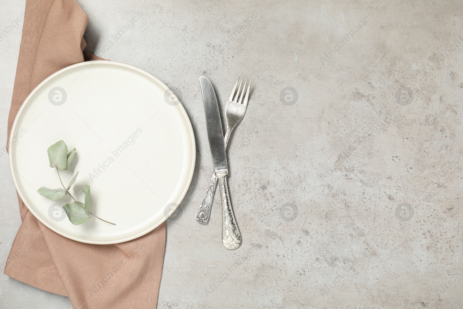 Photo of Setting with beautiful cutlery on textured table, top view. Space for text