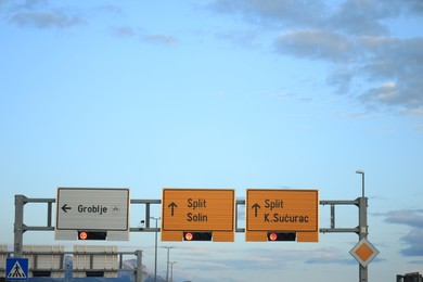 Trogir, Croatia - September 24, 2023: Road signs and traffic signals against blue sky