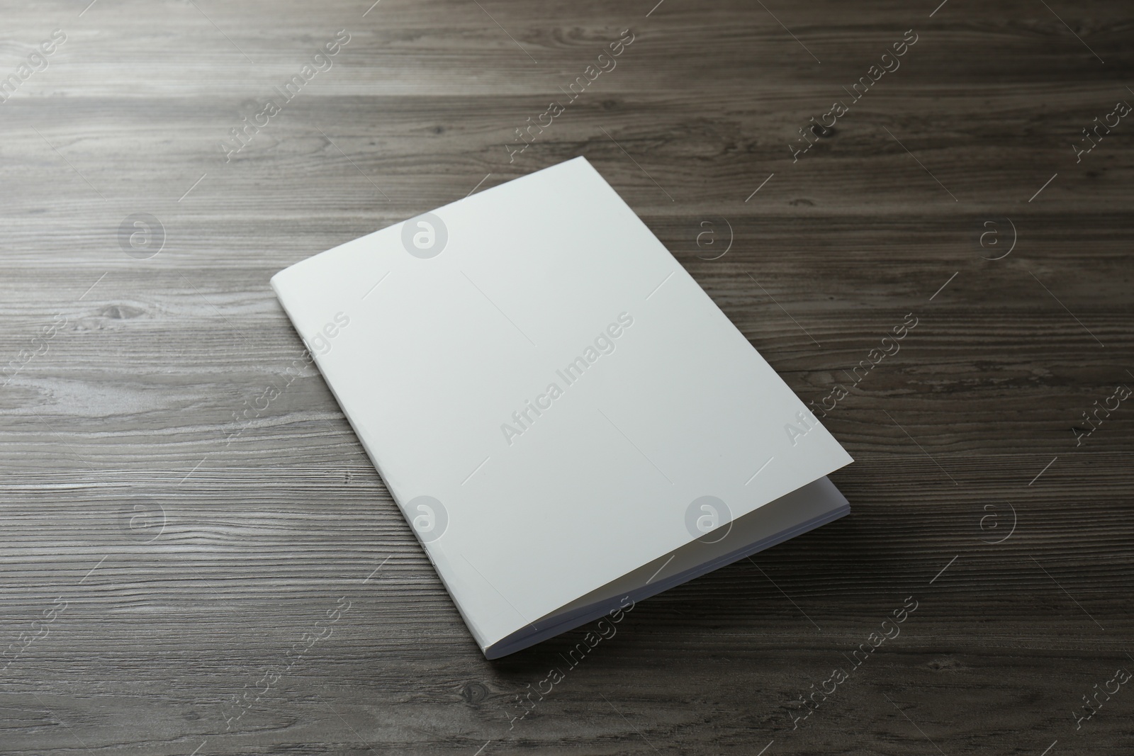 Photo of Blank paper brochure on wooden table. Mockup for design