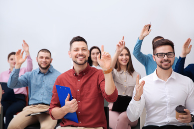 Photo of People raising hands to ask questions at business training on white background
