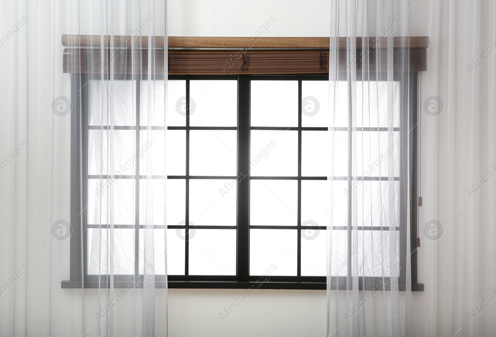 Photo of Window with beautiful curtains and open blinds in room