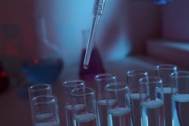 Photo of Dripping reagent into test tube, closeup. Laboratory analysis