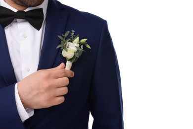 Photo of Groom with boutonniere on white background, closeup. Wedding accessory